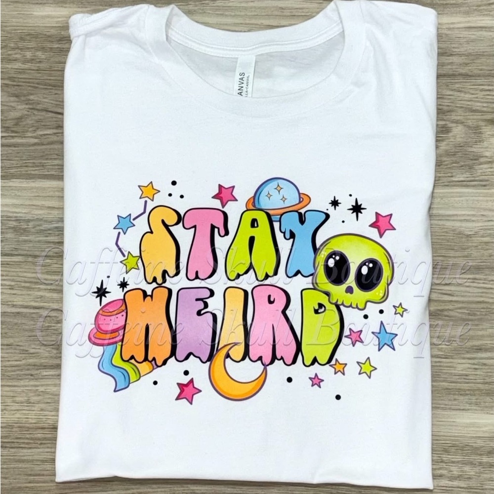 Stay Weird alien Graphic T-Shirt with spaceship and stars